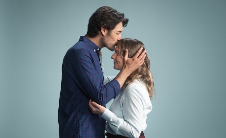 Man kissing woman on the forehead